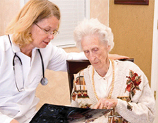 An elder care professional assists a senior